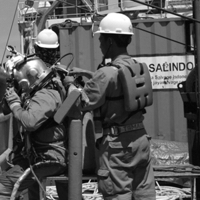 Divers preparing equipment on deck